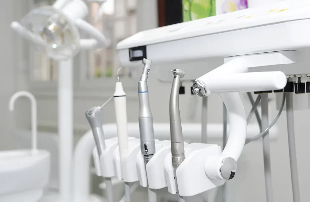 Dental cleaning tools mounted on a cart.