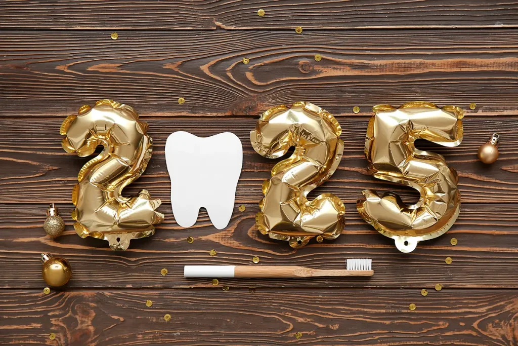 Balloons and a paper cutout of a tooth spelling 2025.