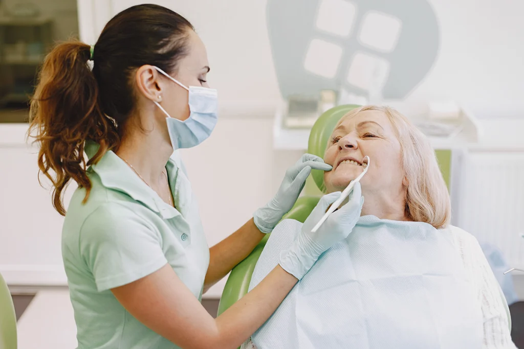 Senior woman having dental treatment at dentist's office.