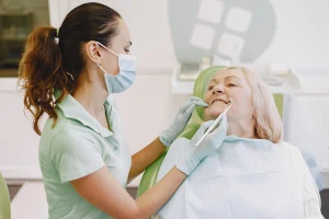Senior woman having dental treatment at dentist's office.